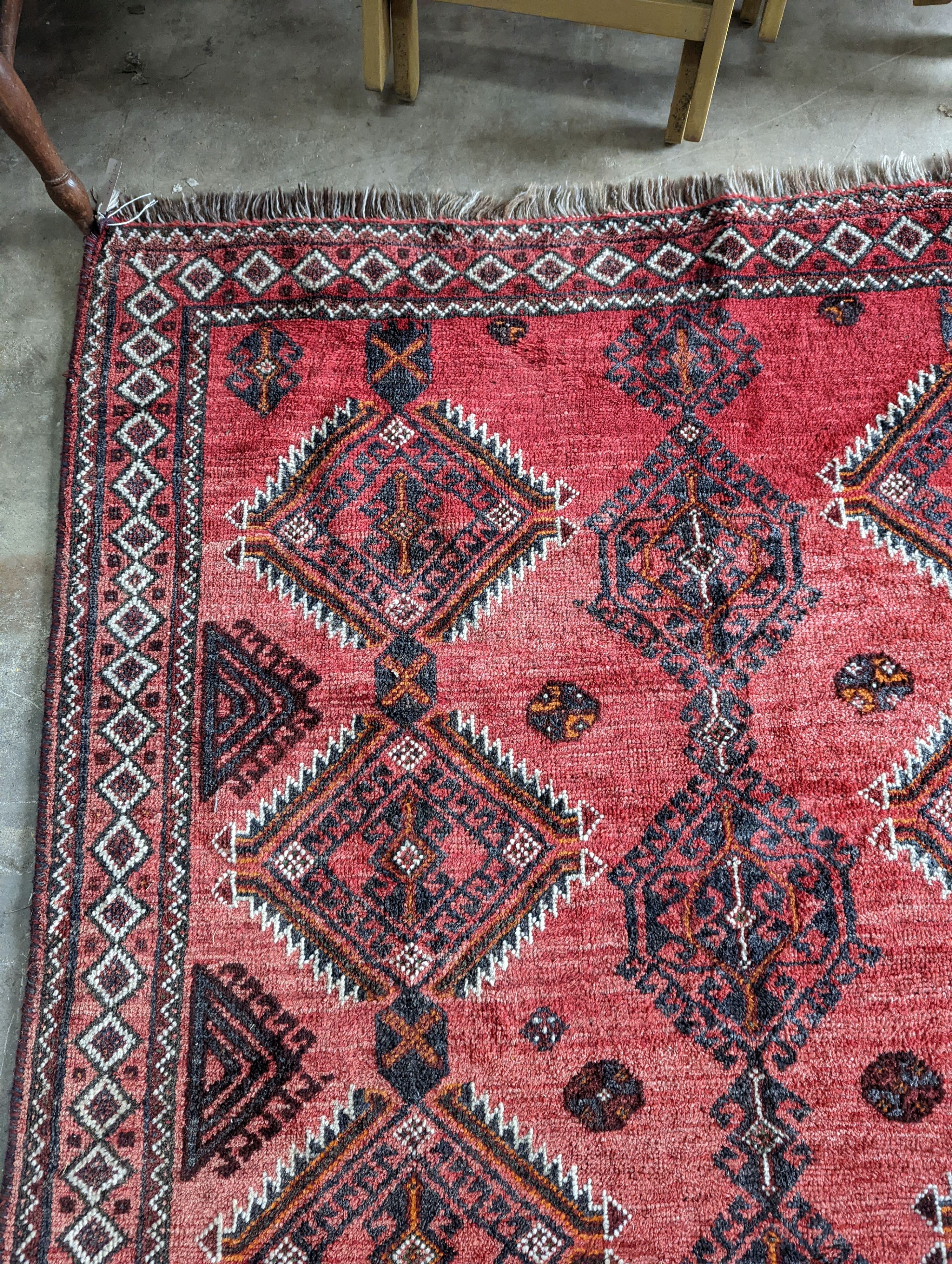 A Caucasian style red ground rug, 255 x 167cm